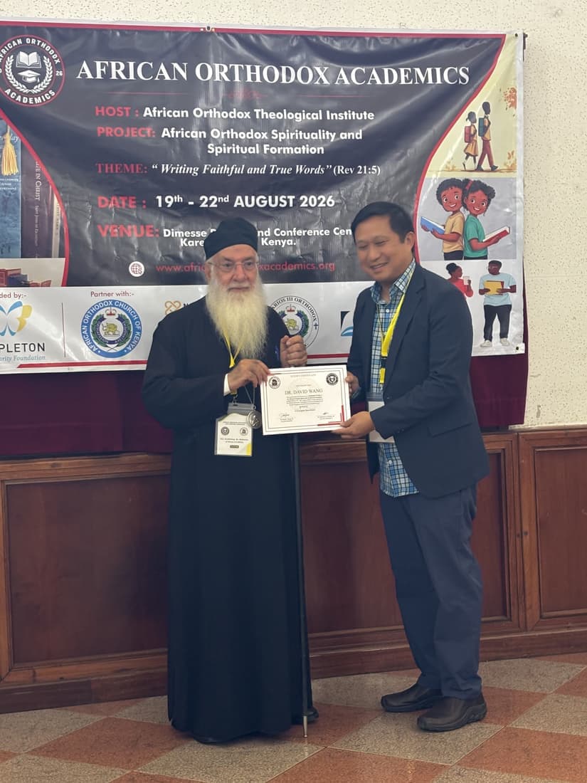 A participant receiving their certificate from the presenting hierarch at the close of the second day.