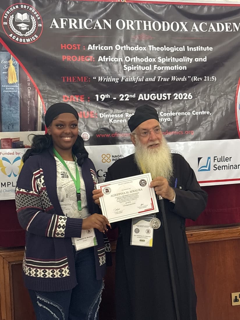 A participant receiving their certificate from the presenting hierarch at the close of the second day.