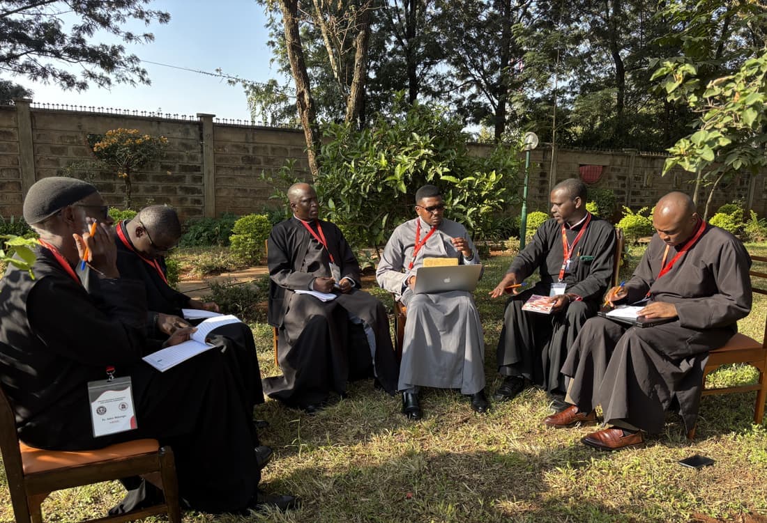 A writing group at work outdoors in the grounds.