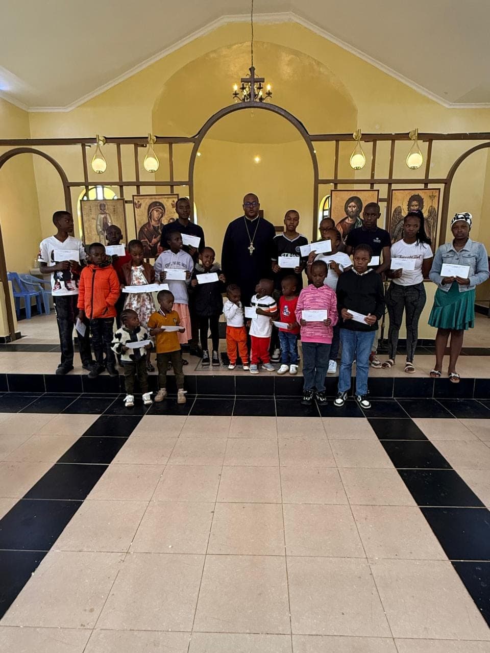 Scholarship recipients lined up across the front of the church holding their award letters.