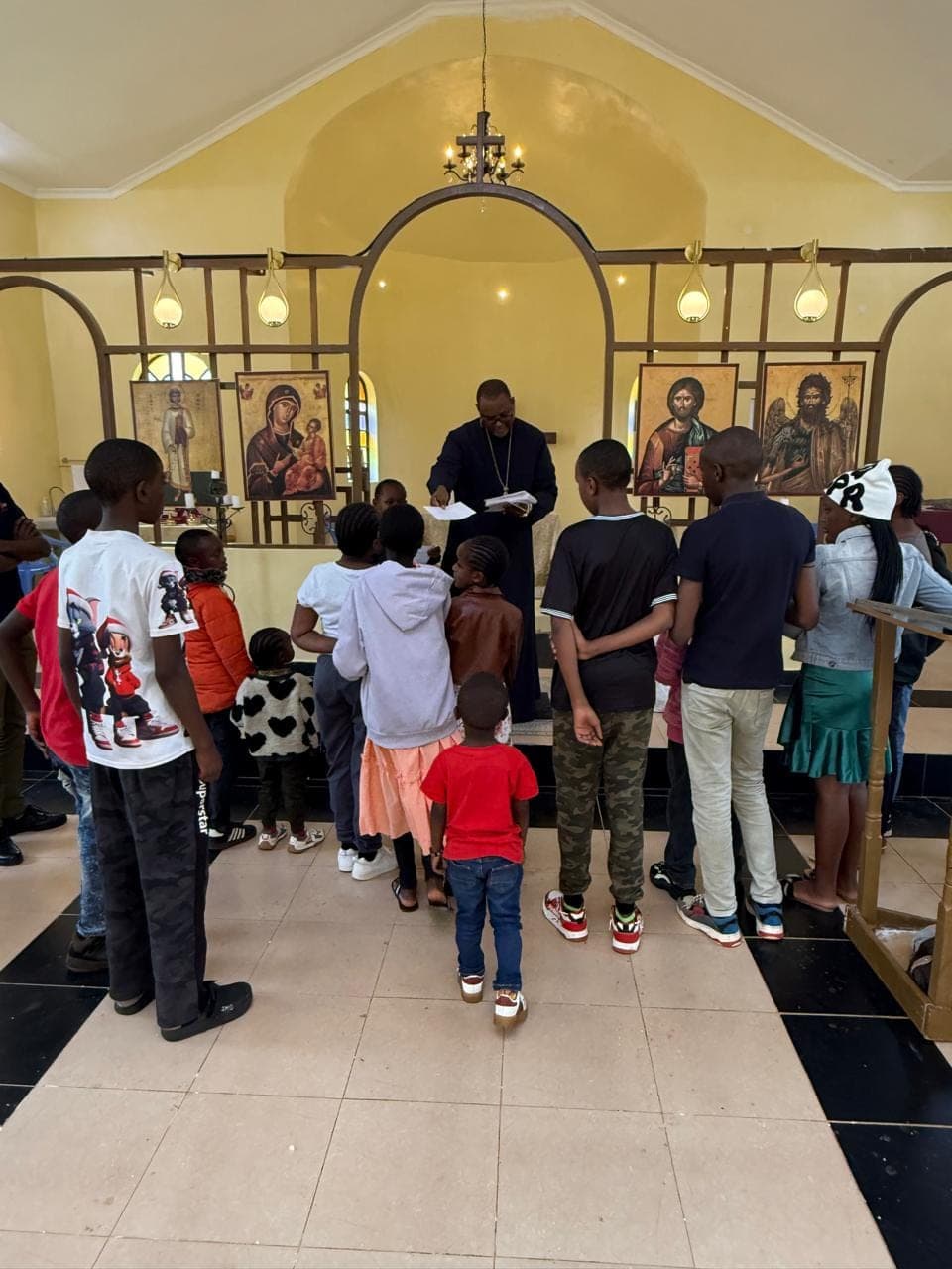 Children queuing in the nave as Fr Thiani reads out the names of scholarship recipients.